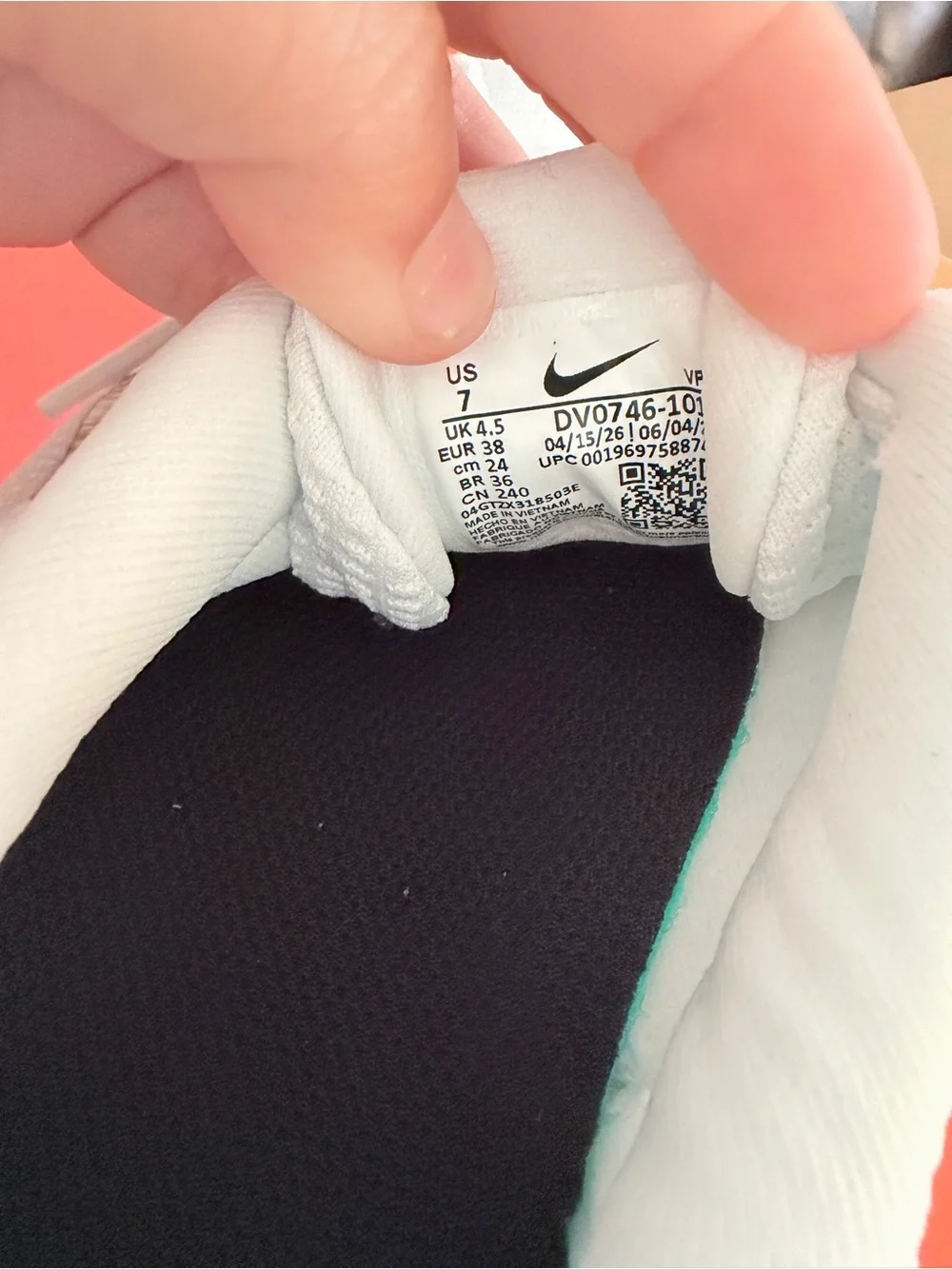 Nike Women's White Sneakers with Silver Swoosh and Black Heel Accent